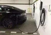 Wall-mounted EV charging in a home garage.